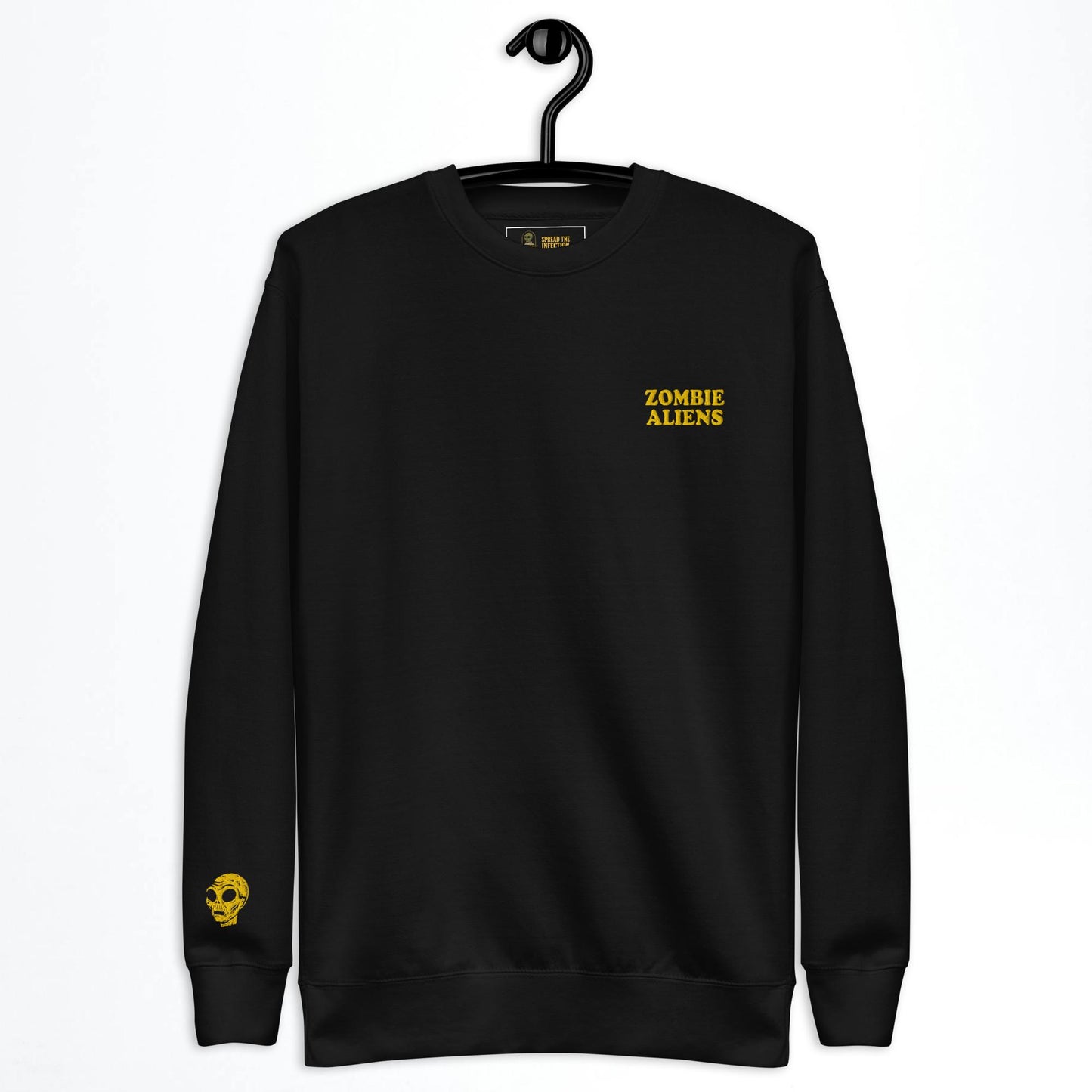 Black sweatshirt with gold text and zombie aliens head design on a hanger against a white background