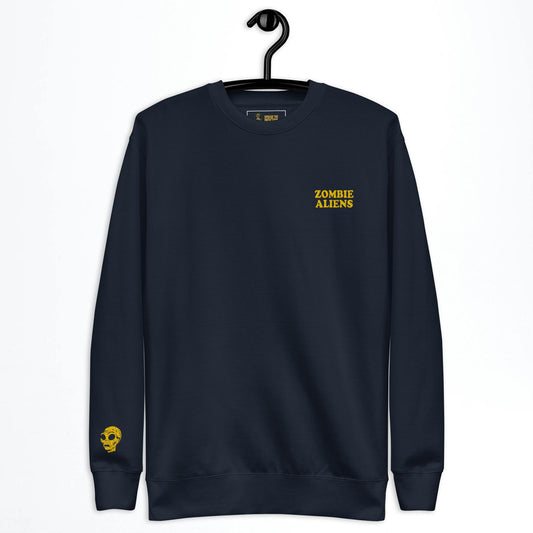 Black sweatshirt with yellow text 'Zombie Aliens' on a hanger against a white background